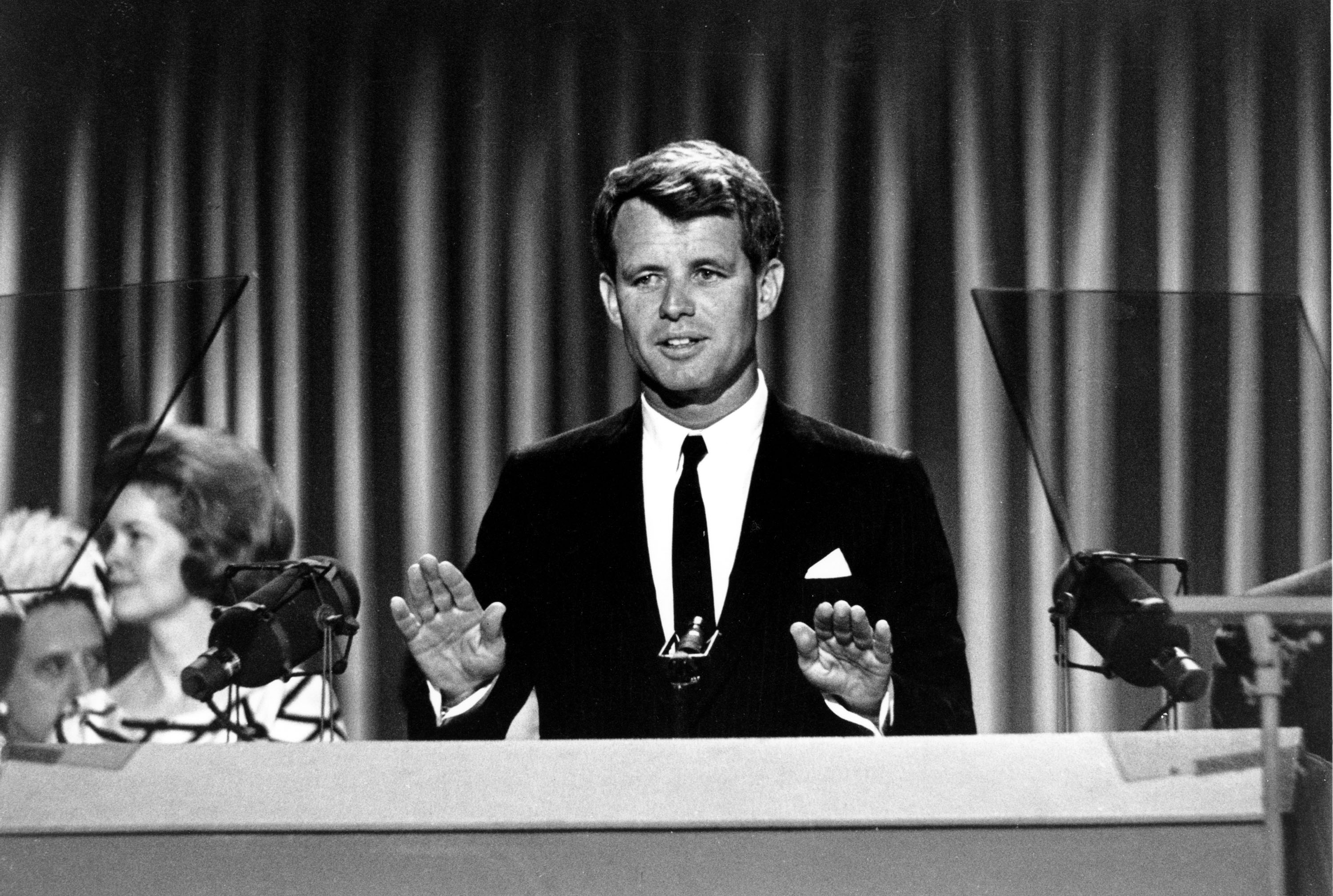 FILE - In this Aug. 28, 1964, file photo, Sen. Robert Kennedy stands before the delegates at the Democratic National Convention in Atlantic City, N.J. Democrats have little hope of matching the fervor and historical import of their 2008 convention, when they made Barack Obama the first black presidential nominee of a major political party. One of the memorable moments from past conventions was delegates standing in tearful silence as Robert Kennedy quotes Shakespeare in tribute to his slain brother, President John F. Kennedy: "When he shall die, take him and cut him out into stars, and he shall make the face of heaven so fine that all the world will be in love with night and pay no worship to the garish sun." (AP Photo)